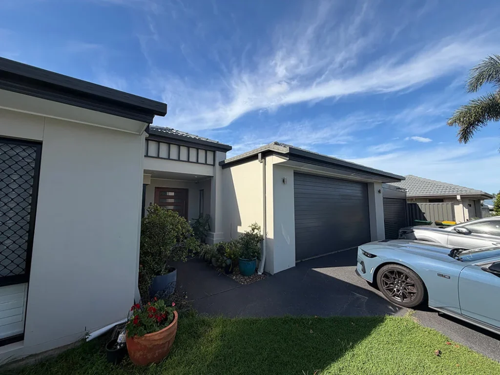Modern home exterior house painting in white render and dark grey trims